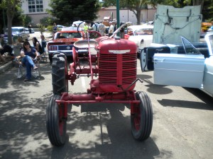 The reason the main part of the tractor is so far to the left is because you can see where you are going, and not run over crops or small animals.  